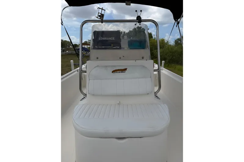 Slide: The Image of 2016 Bulls Bay 2000 boat interior with white seating and Lowrance equipment. - 5