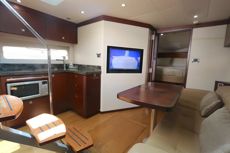 Slide: The Image of Luxurious interior of 2013 Searay 41 yacht with kitchen, seating, and TV. - 12