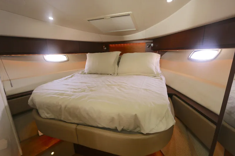 Slide: The Image of Luxurious cabin interior of 2013 Searay 41 yacht with cozy bed and ambient lighting. - 13