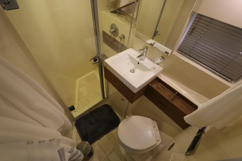 Slide: The Image of Compact bathroom in 2013 Searay 41 yacht with shower, sink, and toilet. - 15