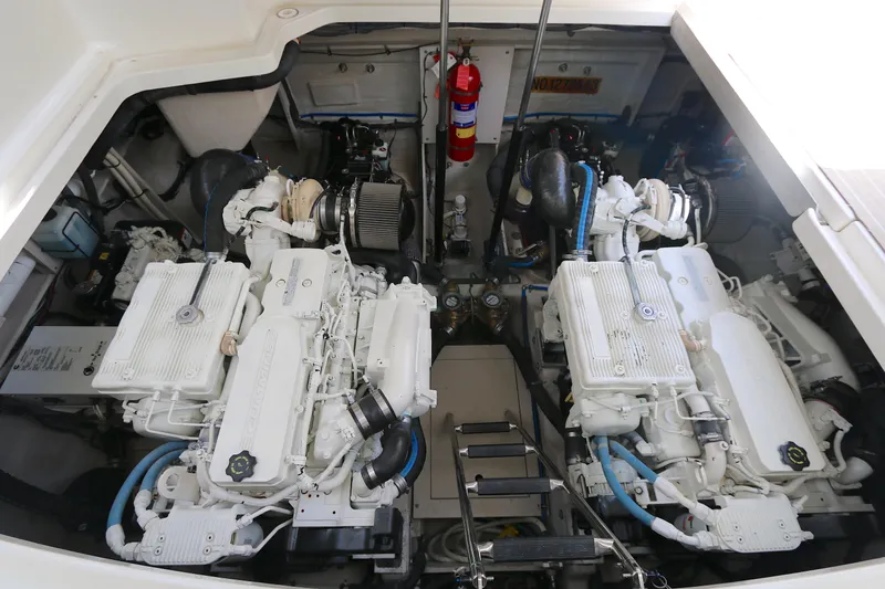 Slide: The Image of Engine room of a 2013 Searay 41 boat, featuring dual engines and fire extinguisher. - 17