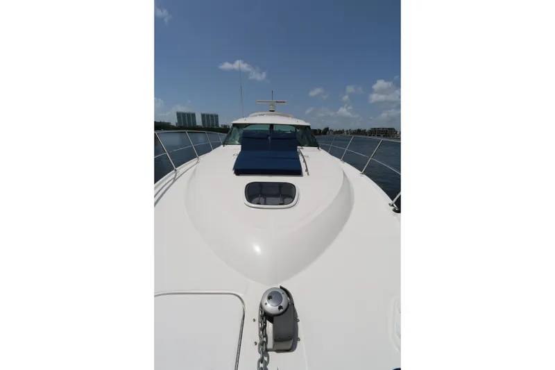 Slide: The Image of 2013 Searay 41 yacht deck with blue cushions, cruising on a sunny day. - 18