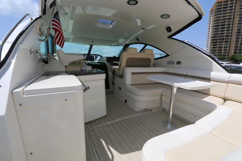 Slide: The Image of Luxurious 2013 Searay 41 yacht interior with seating, table, and kitchenette. - 4