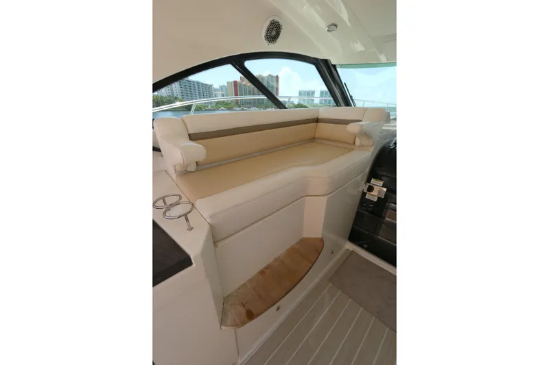Slide: The Image of Interior seating of 2013 Searay 41 yacht with beige upholstery and cup holders. - 7