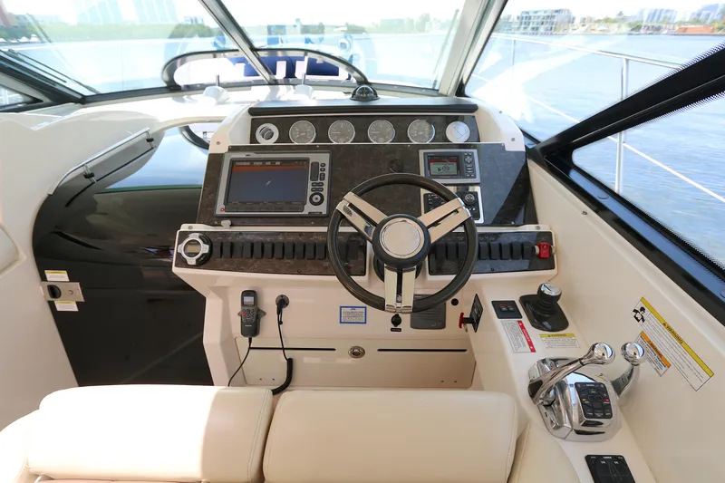 Slide: The Image of Helm of 2013 Searay 41 yacht with modern navigation controls and steering wheel. - 9