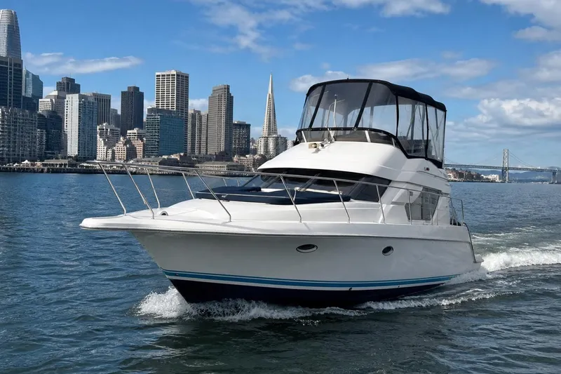 The Image of 1999 Silverton 351 Sedan cruising near city skyline and bridge on a sunny day. - 0