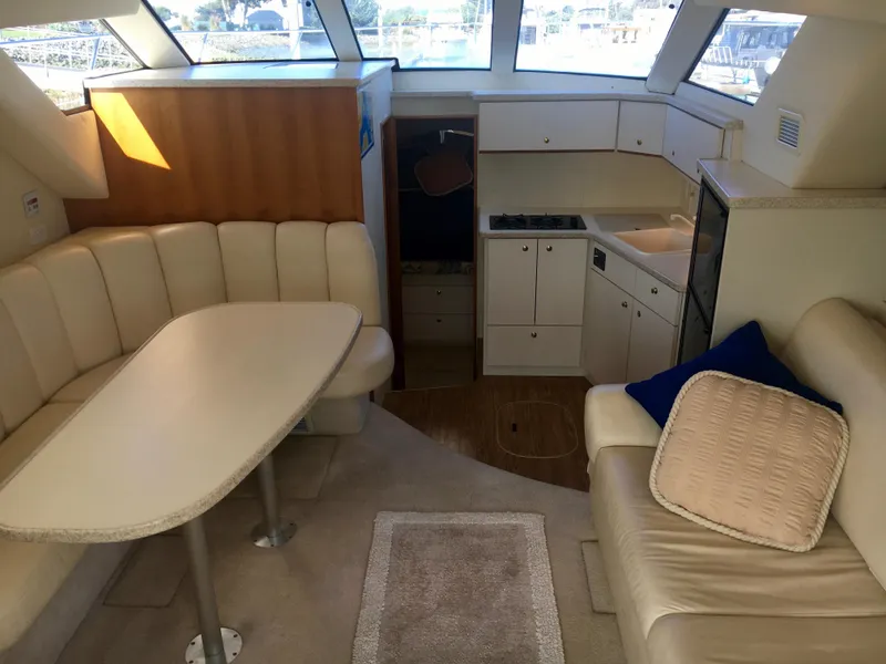 Slide: The Image of Interior of a 1999 Silverton 351 Sedan yacht with kitchen and seating area. - 12