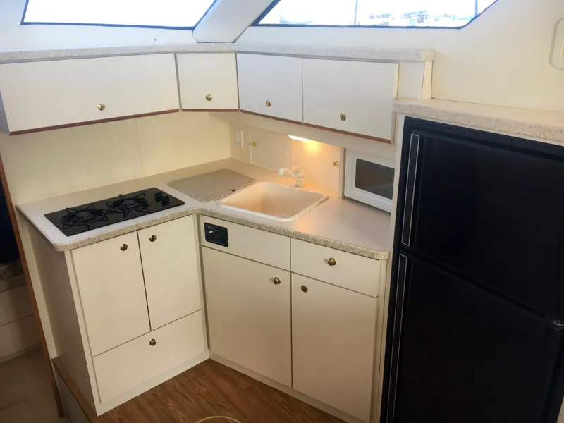 Slide: The Image of Interior of 1999 Silverton 351 Sedan with kitchen and appliances. - 15