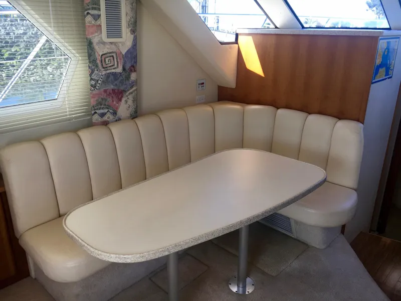 Slide: The Image of Interior of 1999 Silverton 351 Sedan with cushioned seating and table. - 20