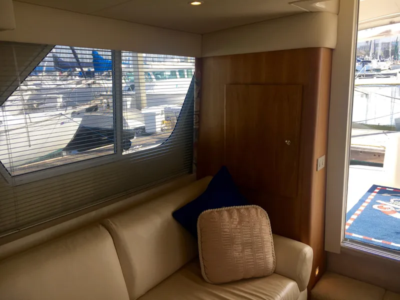 Slide: The Image of Interior of a 1999 Silverton 351 Sedan yacht with sofa and window. - 22