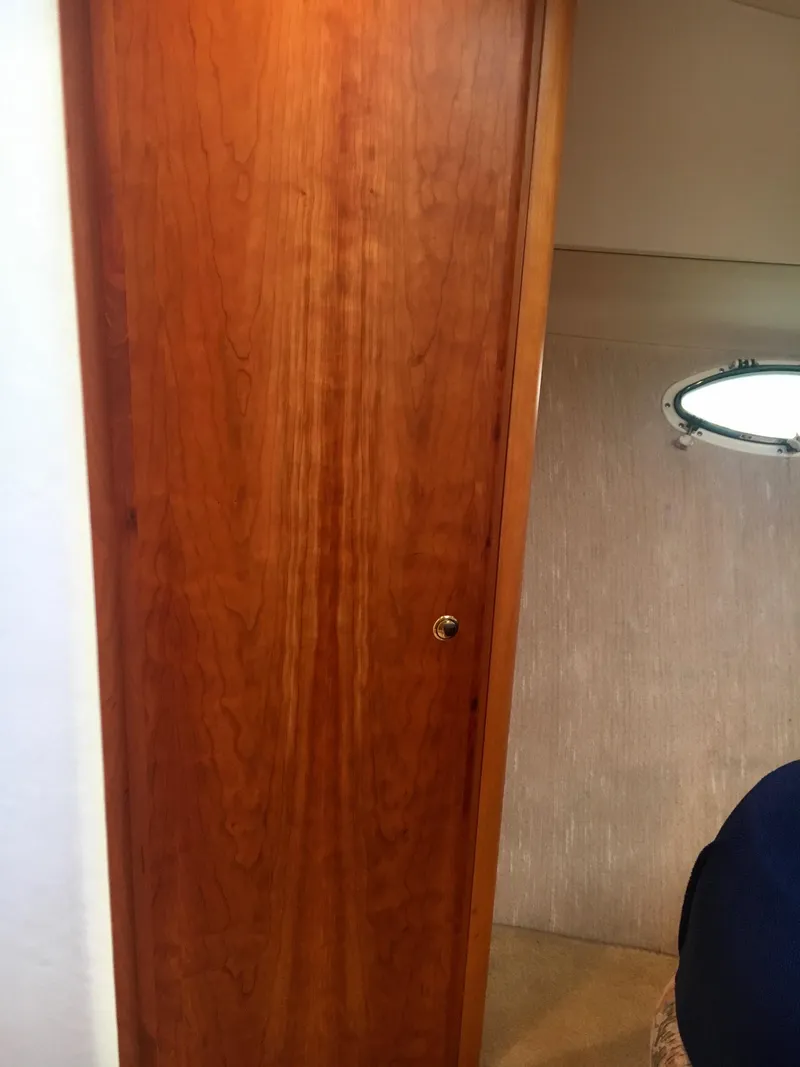 Slide: The Image of Interior of 1999 Silverton 351 Sedan with wooden door and porthole. - 25