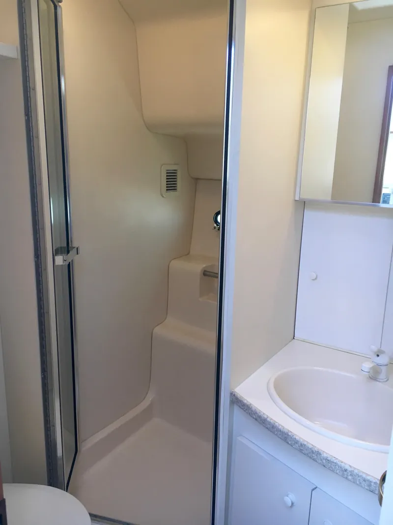 Slide: The Image of Bathroom in 1999 Silverton 351 Sedan with shower and sink. - 27