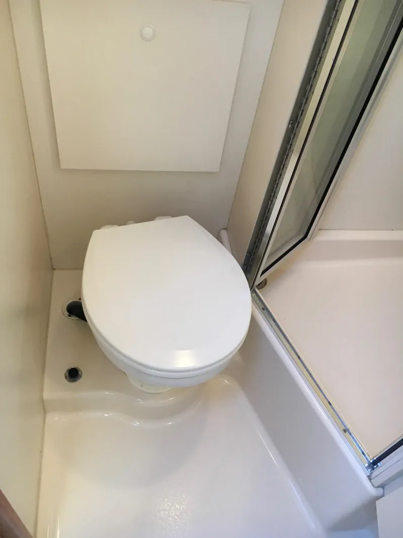 Slide: The Image of 1999 Silverton 351 Sedan bathroom with toilet and shower. - 29