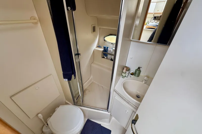 Slide: The Image of Bathroom interior of a 1999 Silverton 351 Sedan yacht with shower and sink. - 31