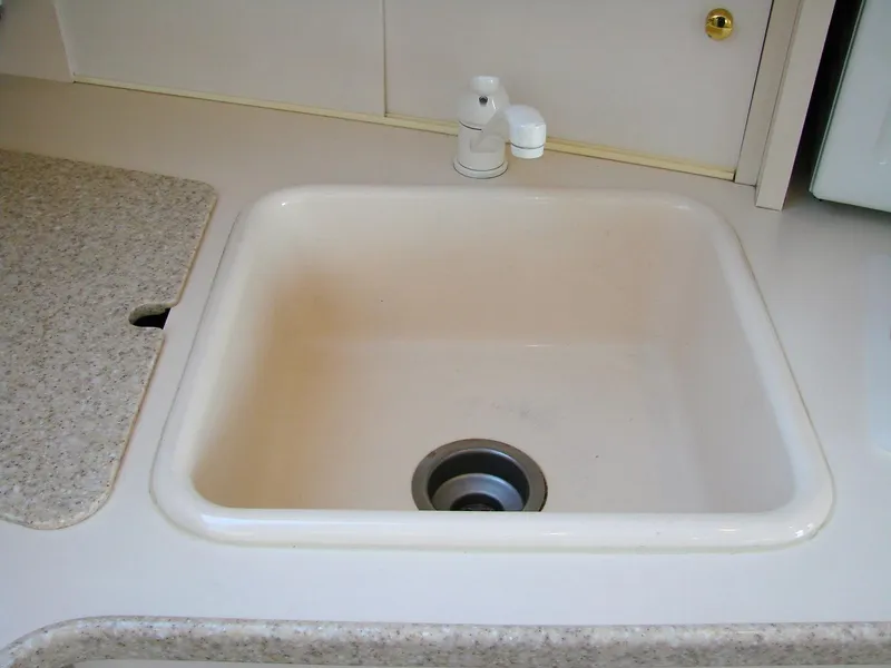 Slide: The Image of Kitchen sink in a 1999 Silverton 351 Sedan yacht. - 44
