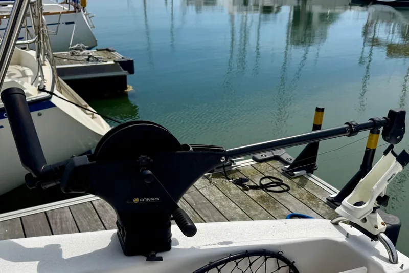 Slide: The Image of Fishing rod holder on a 1999 Silverton 351 Sedan boat at a marina. - 54