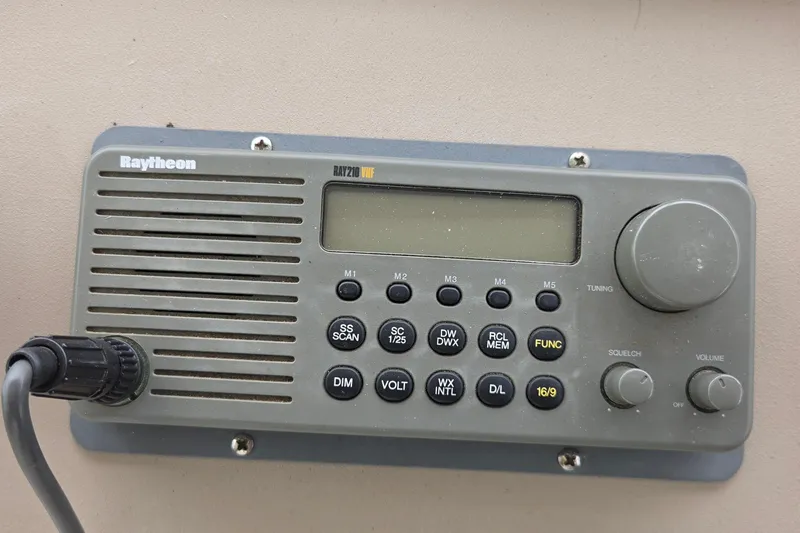 Slide: The Image of Raytheon RAY210 VHF radio on 2002 Sea Ray Sundancer 310 boat dashboard. - 14