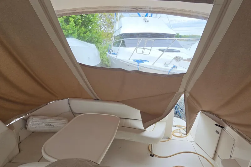 Slide: The Image of 2002 Sea Ray Sundancer 310 interior with beige canopy and seating area. - 22