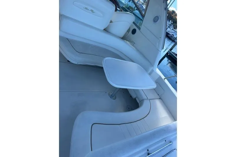 Slide: The Image of Interior view of a 2002 Sea Ray Sundancer 310 boat with white seating and table. - 23