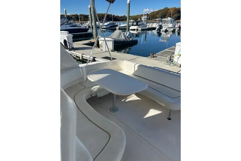 Slide: The Image of 2002 Sea Ray Sundancer 310 yacht with spacious seating at a marina dock. - 25