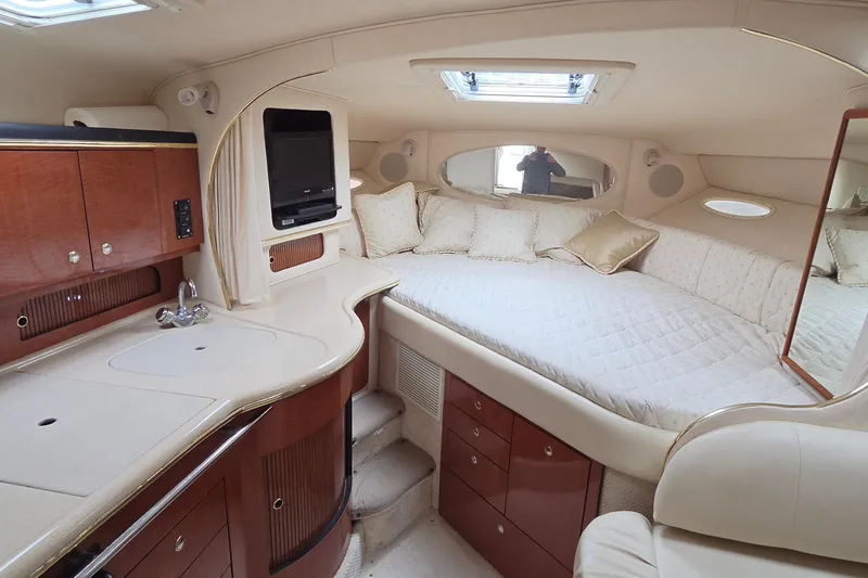 Slide: The Image of Luxurious interior of 2002 Sea Ray Sundancer 310 yacht with cozy bed and kitchenette. - 27