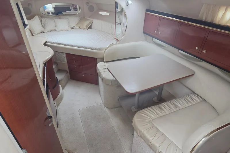 Slide: The Image of Interior of 2002 Sea Ray Sundancer 310 with cozy seating and sleeping area. - 28