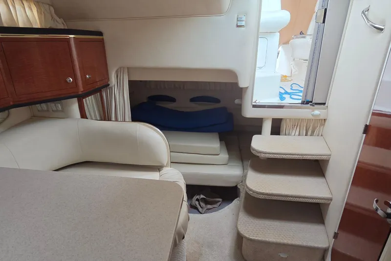 Slide: The Image of Interior of 2002 Sea Ray Sundancer 310, featuring cozy seating and compact cabin space. - 33
