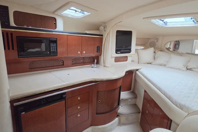 Slide: The Image of Interior of 2002 Sea Ray Sundancer 310 yacht with kitchenette and cozy sleeping area. - 34