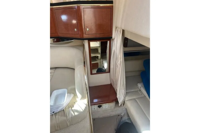 Slide: The Image of Interior of 2002 Sea Ray Sundancer 310 with wood cabinetry and seating area. - 36