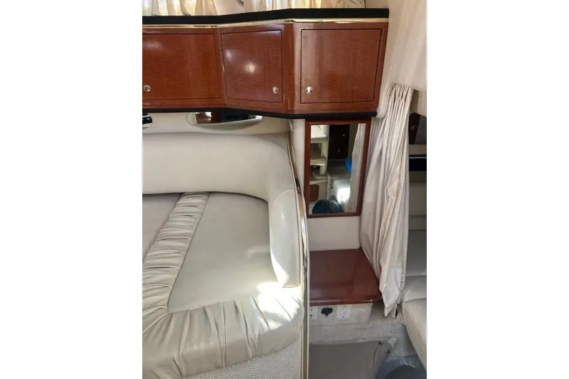 Slide: The Image of Interior of 2002 Sea Ray Sundancer 310 with wood cabinets and beige seating. - 37