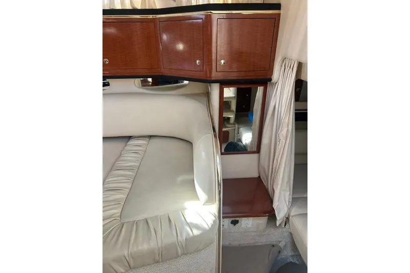 Slide: The Image of Interior of 2002 Sea Ray Sundancer 310 with wood cabinets and cushioned seating. - 38