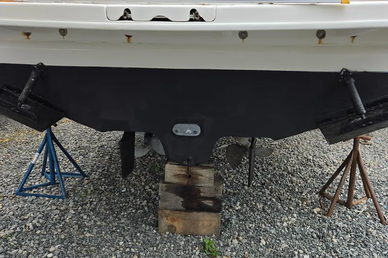 Slide: The Image of 2002 Sea Ray Sundancer 310 boat hull on stands, showing propellers and rudders. - 4