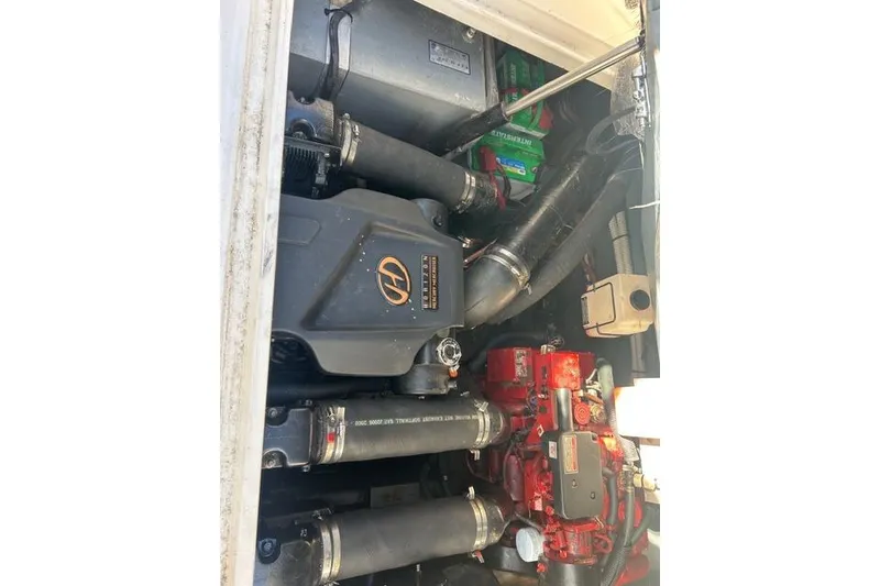 Slide: The Image of Engine compartment of a 2002 Sea Ray Sundancer 310 boat, showcasing mechanical components. - 42