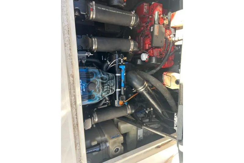 Slide: The Image of Engine compartment of a 2002 Sea Ray Sundancer 310 boat, showcasing mechanical components. - 43