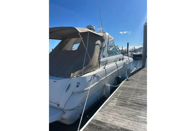 Slide: The Image of 2002 Sea Ray Sundancer 310 docked at marina under clear blue sky. - 7