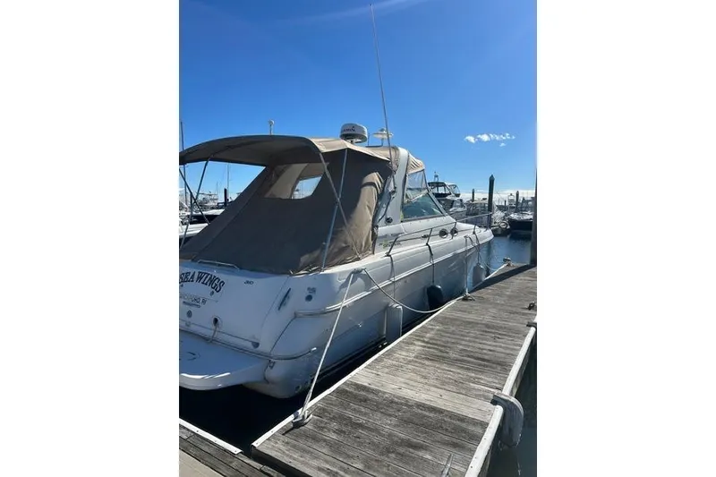 Slide: The Image of 2002 Sea Ray Sundancer 310 docked at marina under clear blue sky. - 8