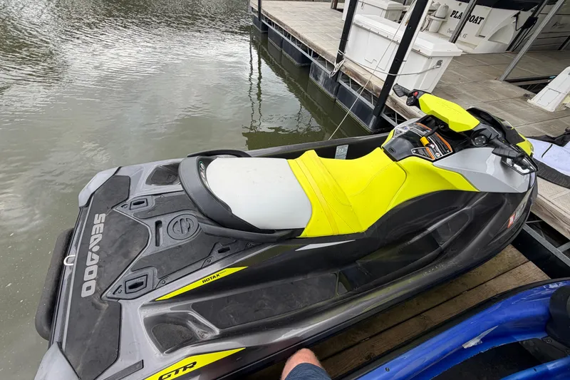 Slide: The Image of 2020 Sea-Doo GTR 230 jet ski docked by the water, featuring a vibrant yellow seat. - 4