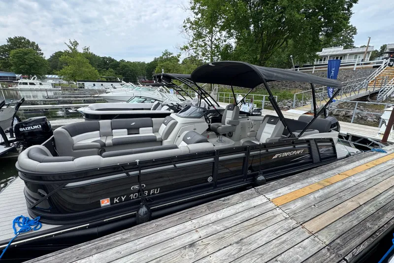 The Image of 2023 Starcraft MX 25 DL DH pontoon boat docked, featuring spacious seating and canopy. - 0