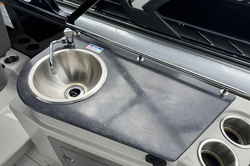 Slide: The Image of 2023 Starcraft MX 25 DL DH boat sink with faucet and countertop. - 11