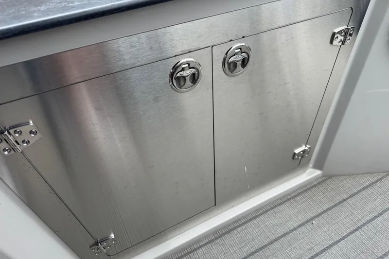 Slide: The Image of Stainless steel cabinet doors on 2023 Starcraft MX 25 DL DH boat. - 16