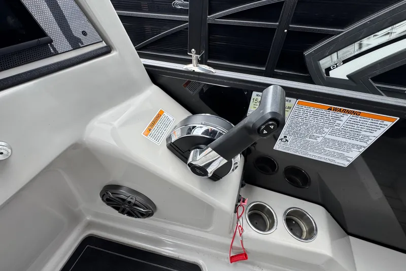 Slide: The Image of Control panel of 2023 Starcraft MX 25 DL DH boat with throttle and warning labels. - 18