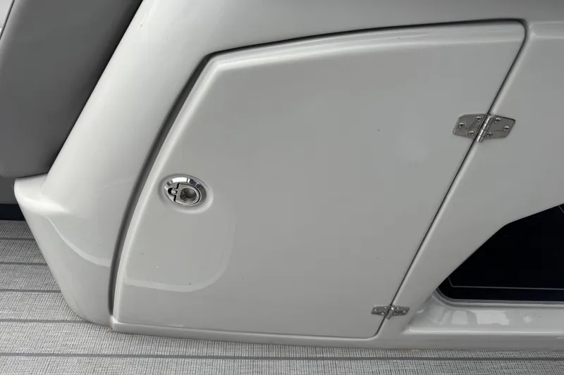 Slide: The Image of 2023 Starcraft MX 25 DL DH boat storage compartment with sleek design and secure latch. - 22