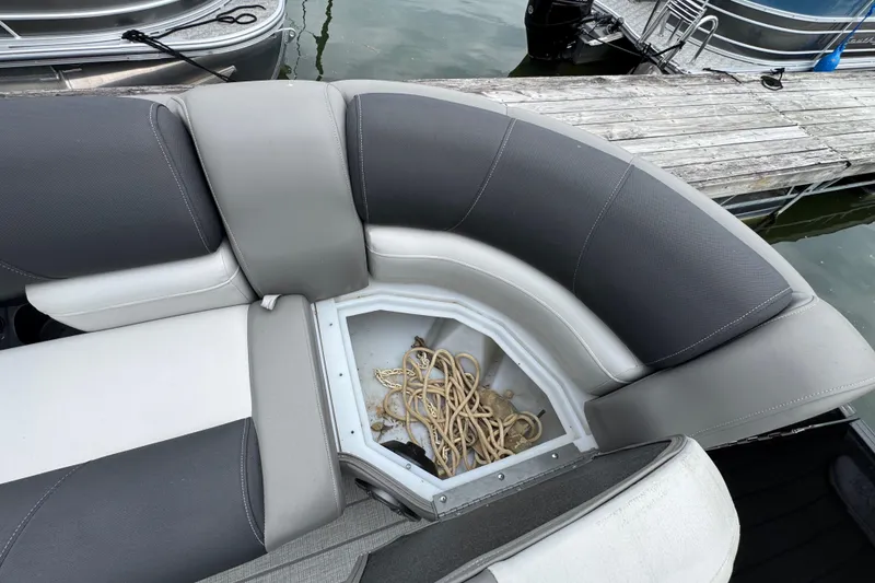 Slide: The Image of 2023 Starcraft MX 25 DL DH boat seating with storage compartment and rope. - 27