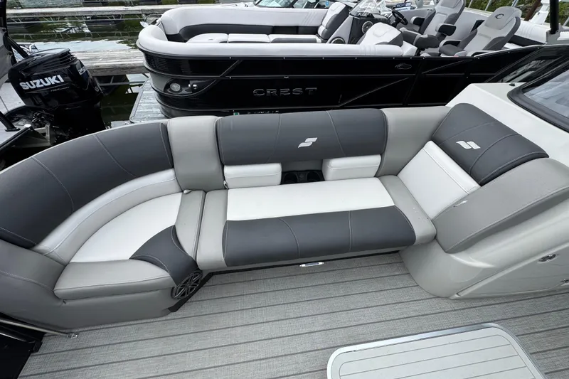 Slide: The Image of 2023 Starcraft MX 25 DL DH boat with sleek gray and white seating. - 29