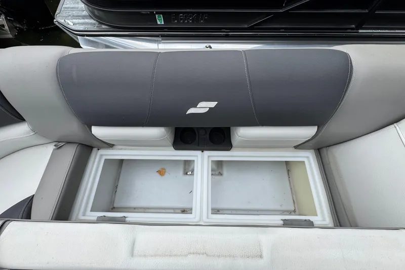 Slide: The Image of 2023 Starcraft MX 25 DL DH boat seat with storage compartments open. - 30