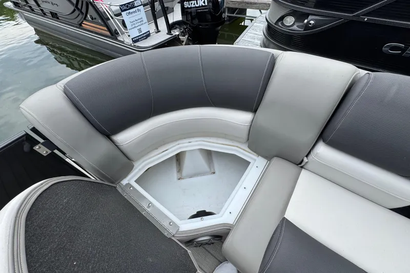Slide: The Image of 2023 Starcraft MX 25 DL DH boat with open storage compartment on cushioned seating. - 31