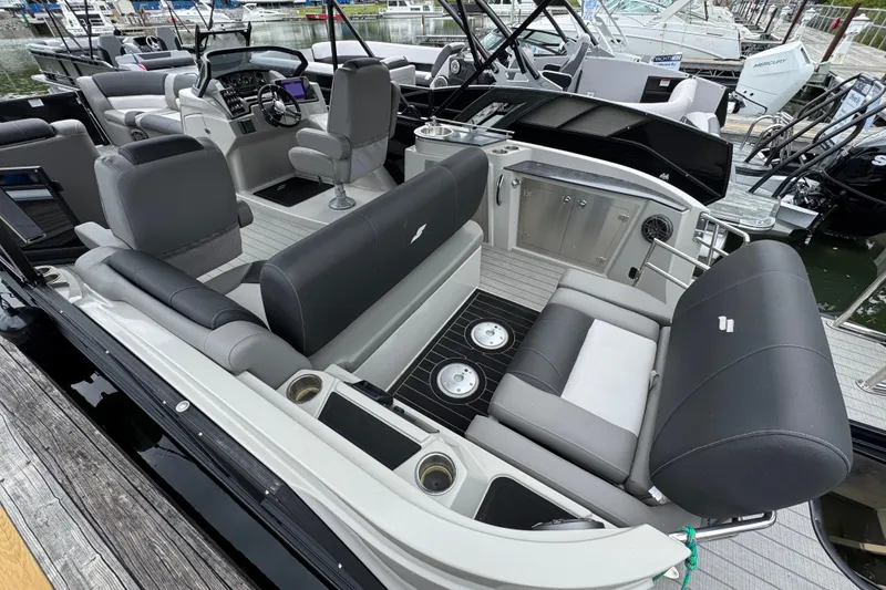 Slide: The Image of 2023 Starcraft MX 25 DL DH pontoon boat interior with luxurious seating and modern dashboard. - 4