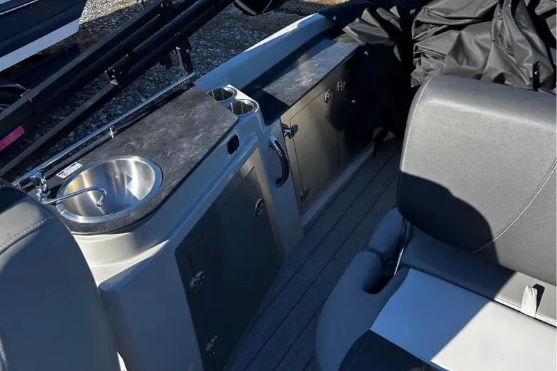 Slide: The Image of 2023 Starcraft MX 25 DL DH boat interior with sink and seating area. - 49