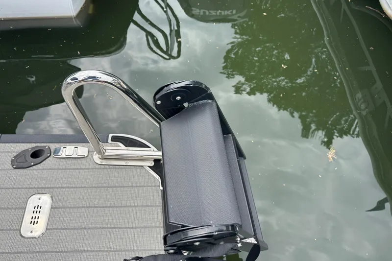 Slide: The Image of 2023 Starcraft MX 25 DL DH boat ladder and deck by the water. - 7