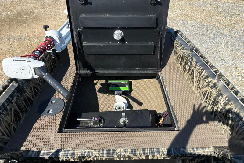 Slide: The Image of 2022 Prodigy 18' PRO VS boat interior with Minn Kota trolling motor and storage compartments. - 11
